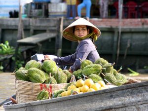 Fruit seller in Cai Be Floating Market of mekong delta